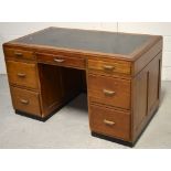 An early 20th century leather top office desk with small metal plaque "H.