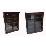 An early 20th century oak double glazed door free standing bookcase with three interior shelves,