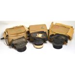 Three boxed WWII gas masks in original canvas carrying pouches (3).