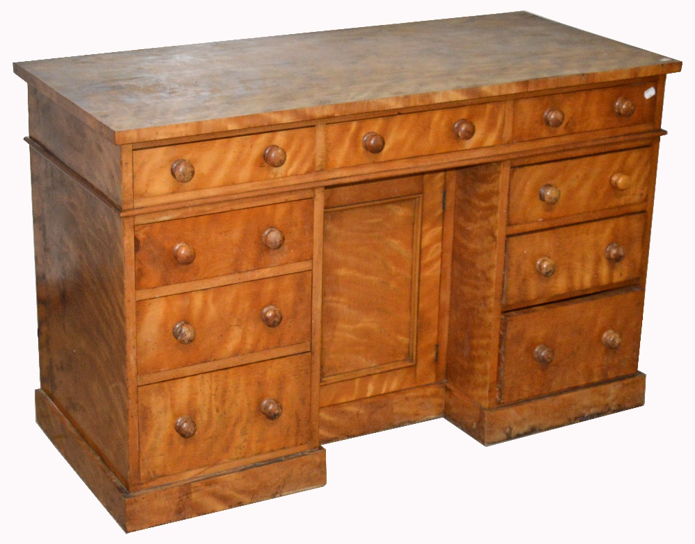 A nine draw pedestal desk on plinth base, width 122cm. CONDITION REPORT Two castors missing.