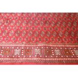 A red ground Bokhara carpet, 230 x 160cm.