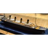 A kit built scale model of the Titanic in perspex case, length including case 92cm.