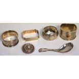 A Georgian hallmarked silver caddy spoon, marks rubbed, four hallmarked silver napkin rings,