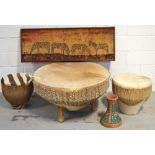 A circular hide covered drum table on triple block supports, width 86cm,