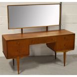 A retro long mirror back dressing table, one central drawer flanked by two drawers on tapering legs,