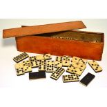 A mahogany box of bone and ebonised dominoes.