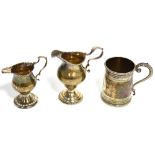 A Victorian hallmarked silver mug, London 1863 and two 19th century hallmarked silver jugs, marks