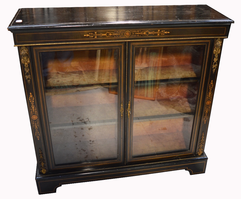 A late 19th early 20th century ebonised inlaid two door display cabinet,