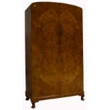 An early 20th century gentlemans walnut wardrobe of small proportions with integral compartments