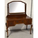 A 20th century mahogany dressing table with three drawers on cabriole legs, width 108cm.