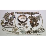 A quantity of silver and white metal jewellery to include two silver charm bracelets,