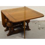 A mid 20th century oak drop leaf dining table on baluster supports, length 164cm.