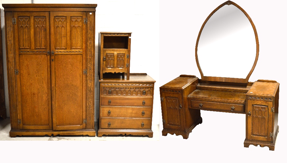 A 20th century oak priory style furniture suite comprising large twin door wardrobe, width 122cm,