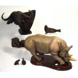 A large contemporary Sherratt and Simpson resin model of a rhinoceros on a wooden base,