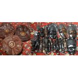 A box of vintage Nigerian figurines, masks, two leather pouffes and a vintage printers tray.