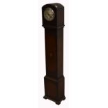 An early 20th century oak cased eight day grandmother clock, silvered dial set with Roman numerals,