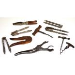 Four vintage corkscrews to include a Lund's London Lever corkscrew and six vintage nut crackers (