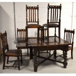 A 20th century oak drawer leaf dining table on barley twist legs,