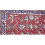 A red ground Turkish rug, approx 200 x 120cm.