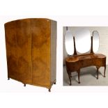 A large early 20th century triple walnut wardrobe on pad feet,