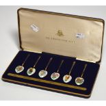 A cased set of six Elizabeth II hallmarked silver gilt and enamel tea spoons, Birmingham 1978,