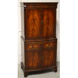 A reproduction flame mahogany drinks cabinet on bracket feet, width 72cm.