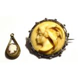 A circular ivory cameo in a white metal mount and a cameo pendant (2).