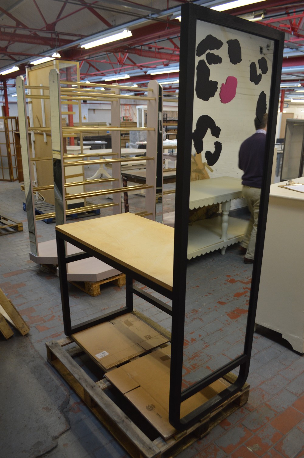 A stained wooden framed shop fitting with mirrored end and shelf attachment, width 121cm.