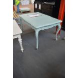 A pale green painted dining table in the French taste,