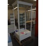 A white painted shop display unit with open front, back and sides,