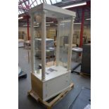 A white painted shop display cabinet, with glazed ends,