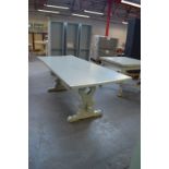 A painted refectory table raised on pierced end supports united by a central stretcher, 208 x 86cm.