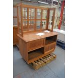 A walnut veneered shop fitting with glazed upper section set with brackets for shelves (shelves