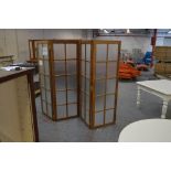 A three-fold four panelled dressing screen with frosted glass panels (two panels cracked),