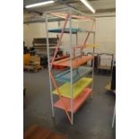 A brightly decorated set of metal shop shelves, width 121cm.