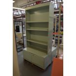 A pair of pale green painted bookcases on cupboard,