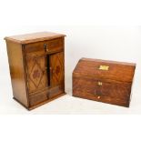 An early 20th century table cabinet with two opening doors enclosing a rack, between two drawers,