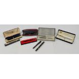 A group of various pens and fountain pens including a Parker three piece set,