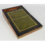 An Edwardian walnut writing slope with brass mounts and central lozenge cartouche with inset brass