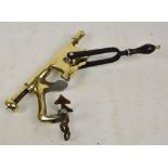 A large bar mounted polished brass and wooden handled corkscrew, inscribed "The Acme".