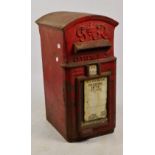 A George V red painted cast iron post box, retaining collection details for 672 Station Road.