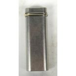 A 1970s Cartier white and yellow metal pocket lighter of plain oval form with decorative band to