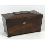 An early Victorian rosewood sarcophagus tea caddy,