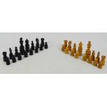 An early 20th century turned wooden and stained chess set, height of king 11cm, contained within a