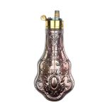 A good embossed copper powder flask, of pistol size and retaining virtually all of its original