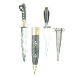 Two Horn Mounted Eastern Daggers, the first with 18cm wavy blade, carved horn hilt set with mother-