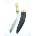 An Ivory Hilted Kukri, 25cm sharply curved blade with two short fullers and etched with scrolling