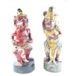 A Balinese Kris Stand, the carved and painted god-like figure together with another similar in the