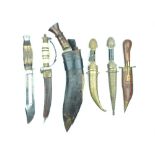 A Small Collection of Daggers and Knives, comprising a Kukri, an eagle pommelled dagger, two brass