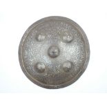 An Indo-Persian Damascene Shield, the 35.5cm diameter steel shield decorated over all in silver